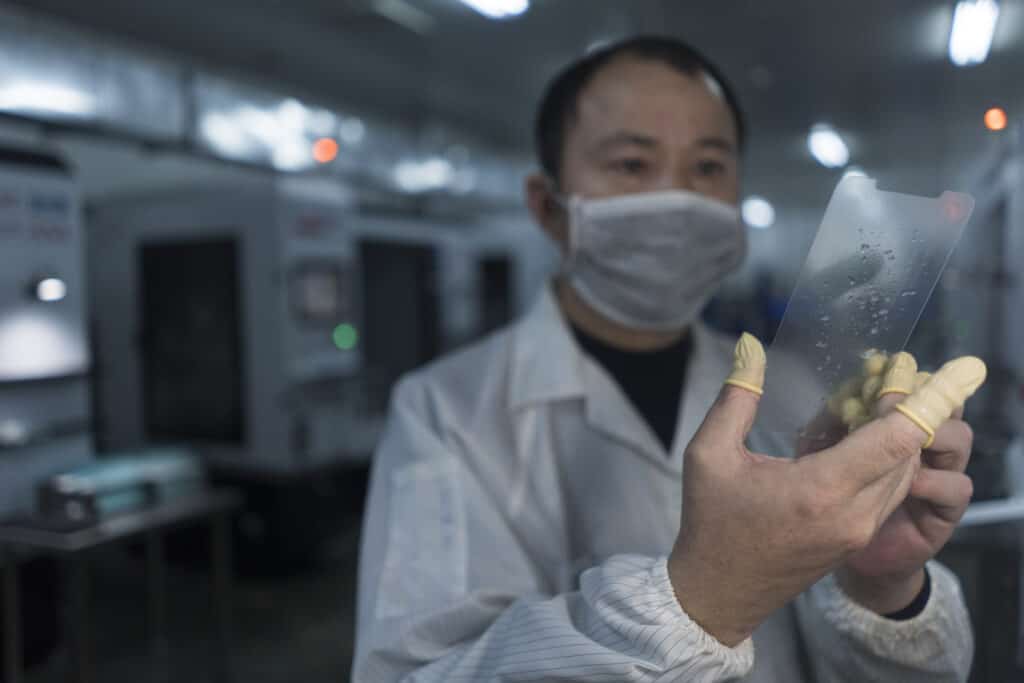 factory worker inspecting screen protector